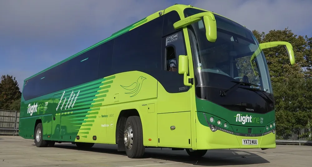 Green coach with Reading Buses logo parked on a road