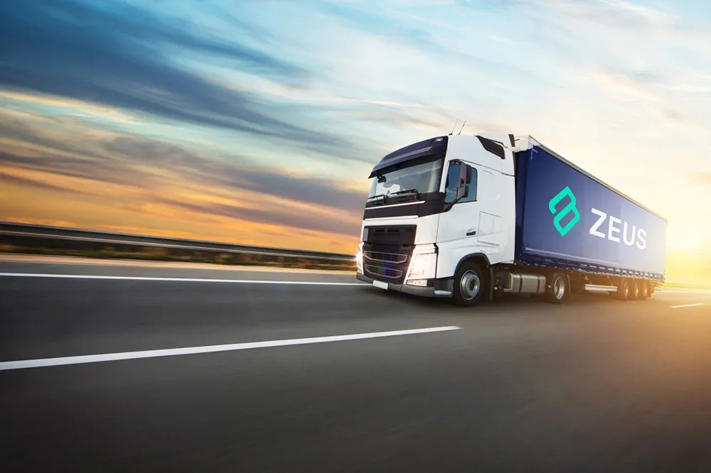 Lorry on road with sunset with Zeus logo on the side