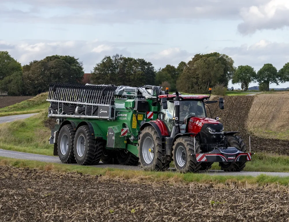 Vredestein Flotation Trac Tyre in action on a Tractor pulling a green slurry trailer.