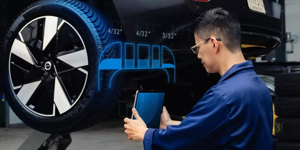 Technician using Anyline AI technology on a tablet on a tyre