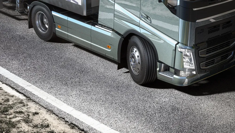 Laufenn Tyre on a Grey Truck on a road with the top half cut off.