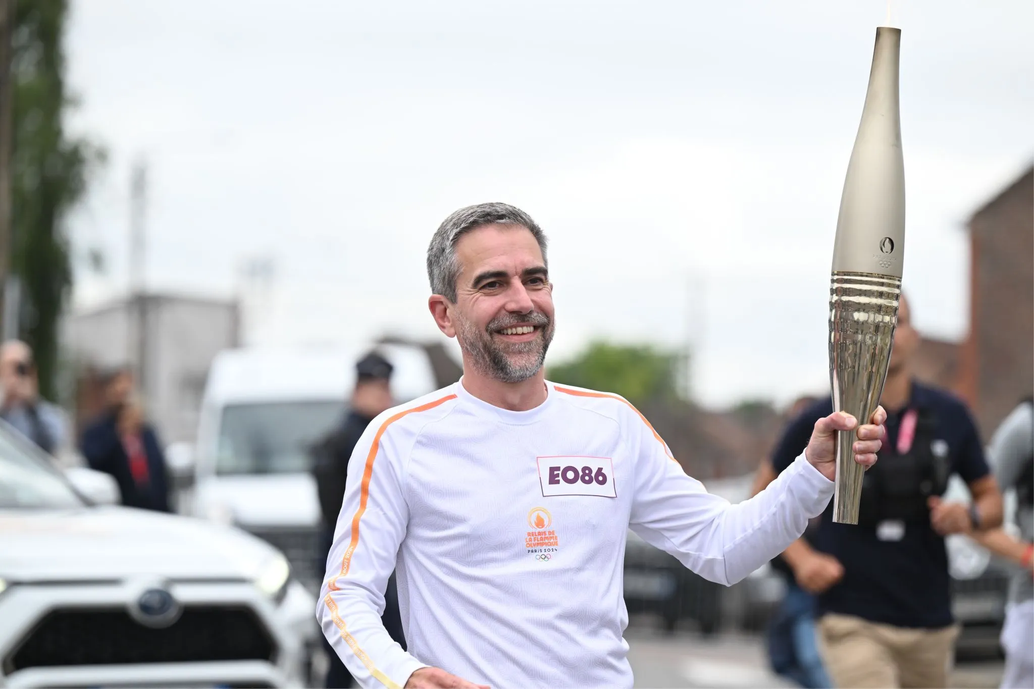 Andy Mathis, Head of Marketing at Bridgestone EMEA holding the Olympic torch