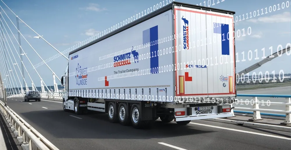 White Truck with Goodyear Tyres on driving across bridge with binary code across the top of the image