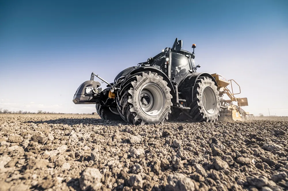 Tractor with TrelleborgTires ProgressiveTraction on soil and a blue sky