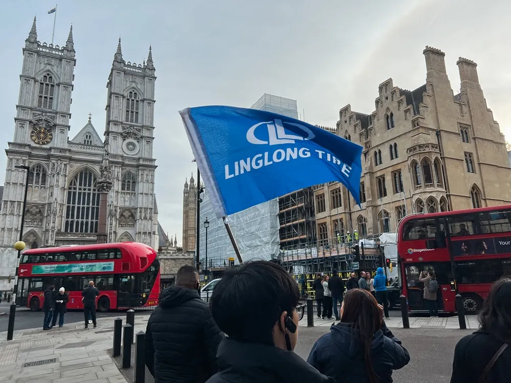 Linglon tire flag in blue being waved in central London with historic style buildings in the background