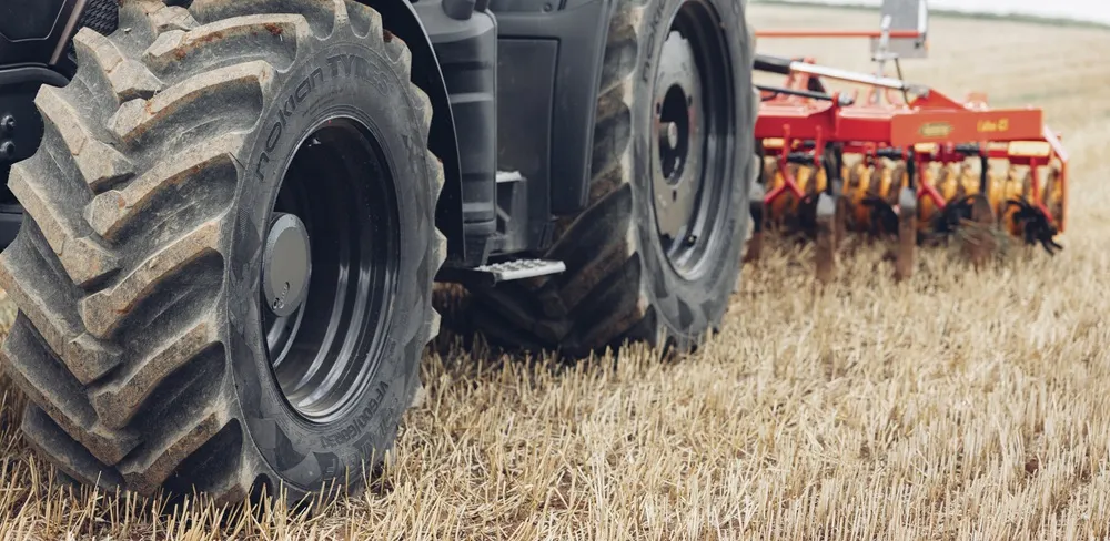Nokian Tyres Soil King VF Range on a tractor pulling a plough in a wheat field.