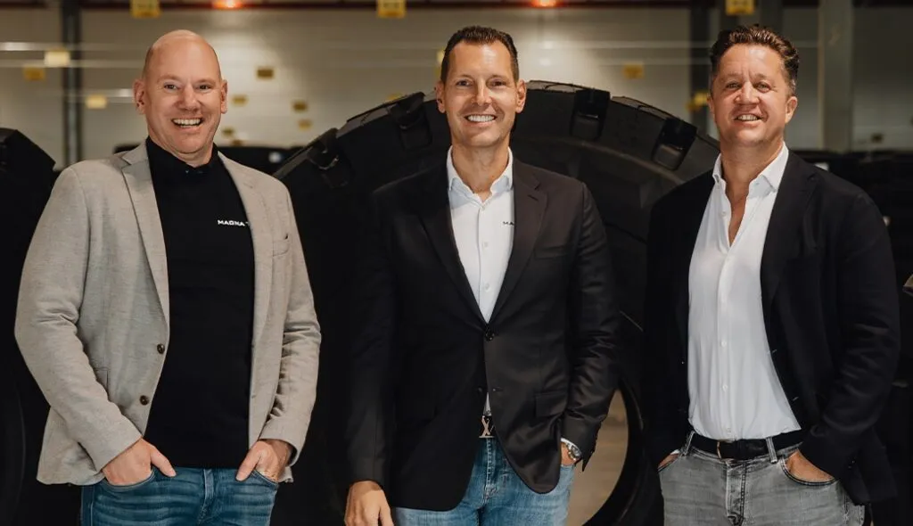 Image of the Magna Tyres Group leadership of three white men standing in a row and smiling.