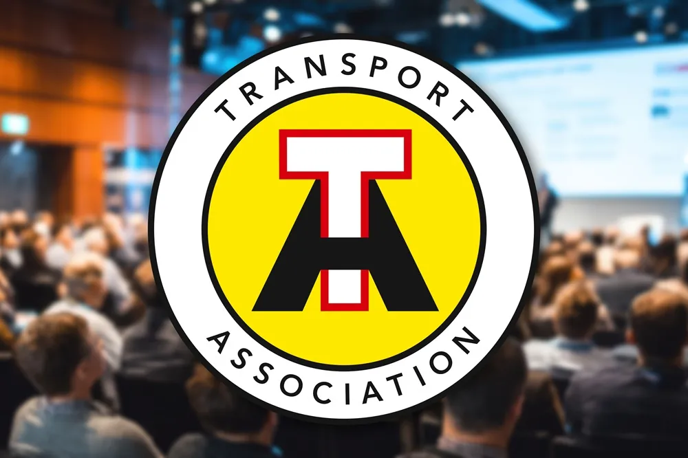 Image of the Transport Association logo with blurred crwod in the background