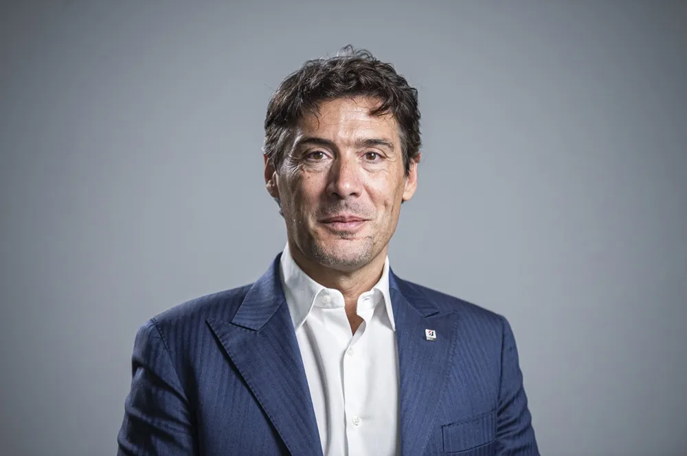 Image of Stefano Sanchini from Bridgestone wearing a dark suit and white shirt